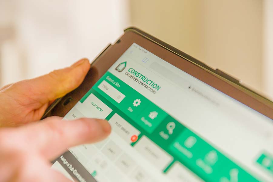 Close up view of LJ Construction's contractor management software on a tablet device.
